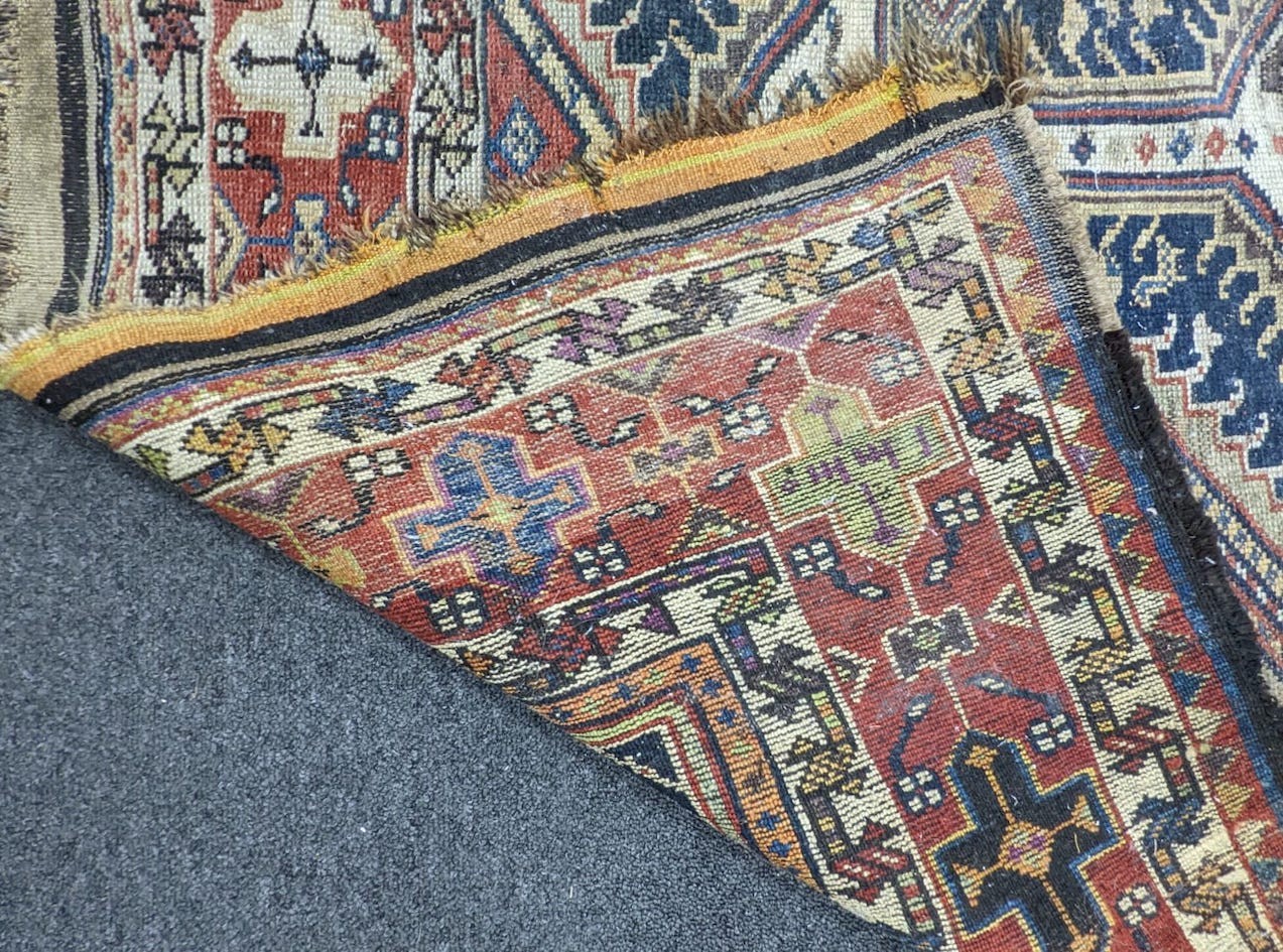 A pair of antique Caucasian blue ground rugs, 290 x 132cm